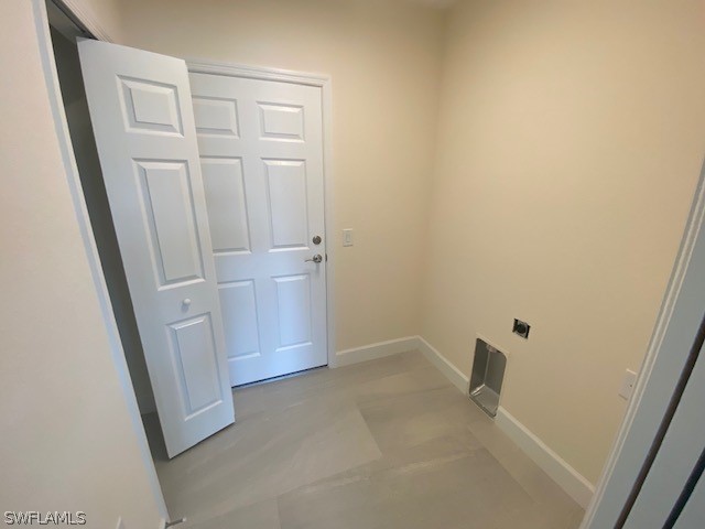 laundry area featuring light tile patterned flooring and hookup for an electric dryer