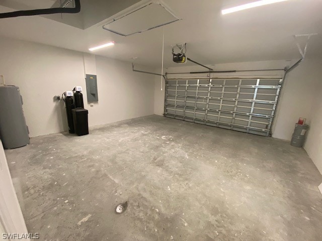 garage with water heater, a garage door opener, and electric panel