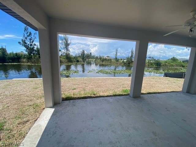 view of patio / terrace featuring a water view and ceiling fan