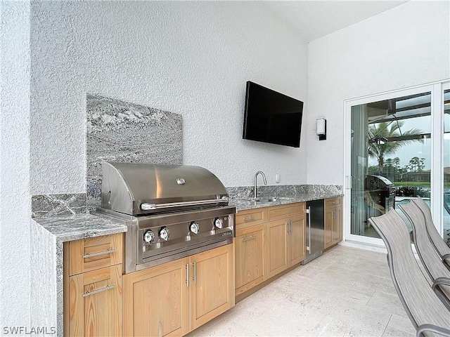 view of patio featuring an outdoor kitchen, grilling area, and sink