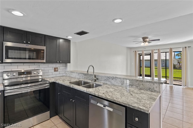 kitchen featuring sink, kitchen peninsula, and appliances with stainless steel finishes