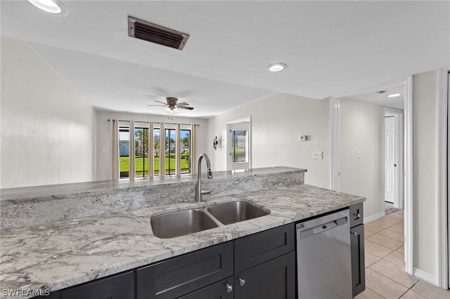 kitchen with light stone countertops, stainless steel dishwasher, light tile patterned floors, ceiling fan, and sink