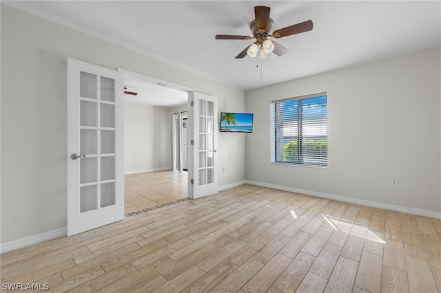 unfurnished room with french doors, light wood-type flooring, and ceiling fan