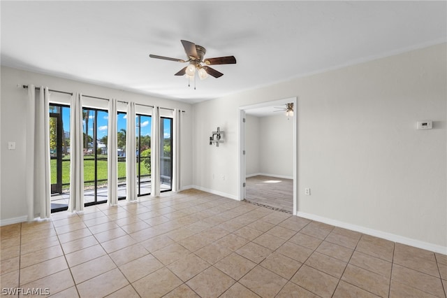 unfurnished room with ceiling fan and light tile patterned floors