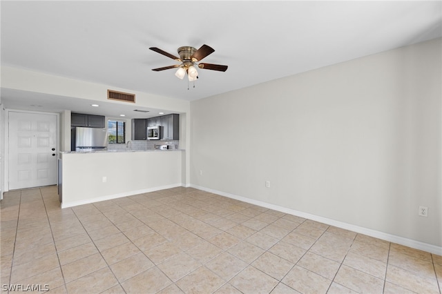 unfurnished living room with ceiling fan and light tile patterned floors