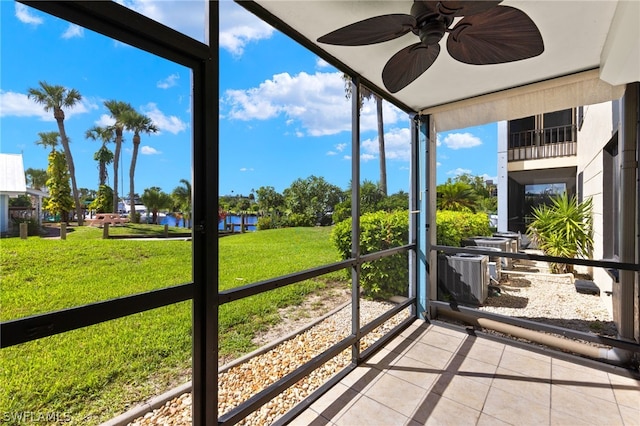 unfurnished sunroom with ceiling fan