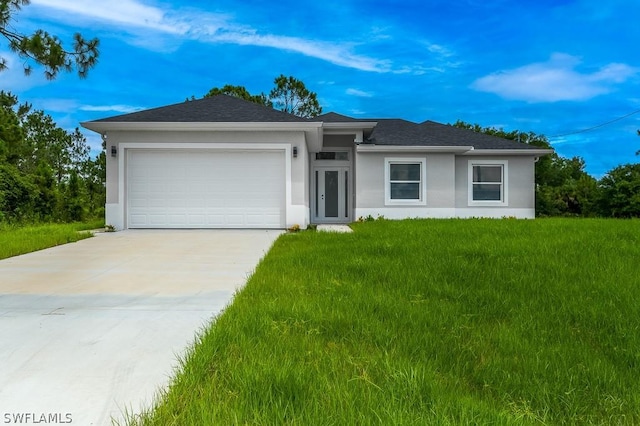 view of front of property with a front lawn and a garage