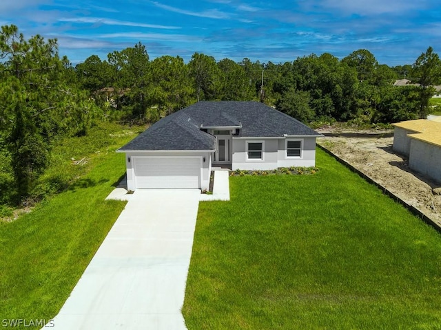 ranch-style house with a garage and a front lawn