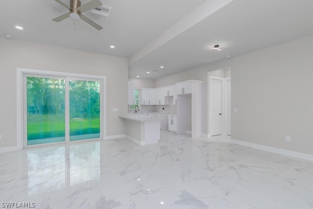 unfurnished living room with ceiling fan