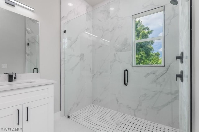 bathroom featuring vanity and a shower with shower door