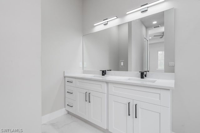 bathroom featuring ceiling fan and vanity