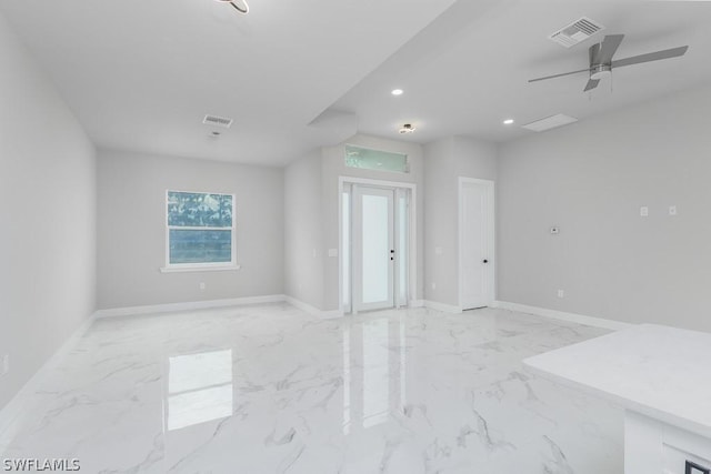 empty room with ceiling fan and french doors