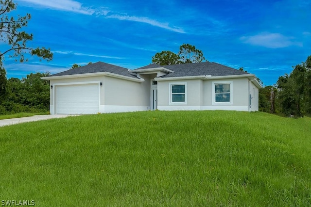 view of front facade with a garage and a front lawn