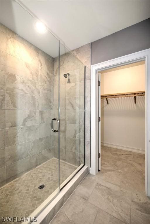 bathroom with a shower with door