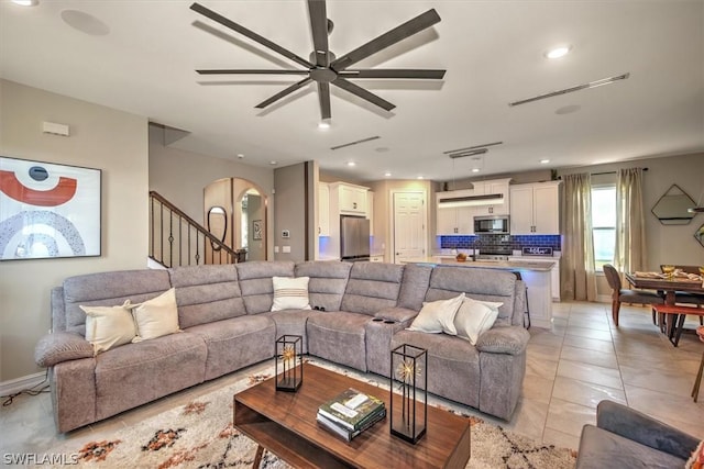 tiled living room featuring ceiling fan