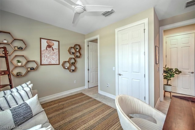 interior space with ceiling fan