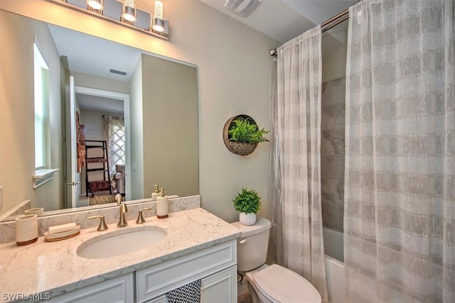 full bathroom with shower / bath combo with shower curtain, vanity, and toilet