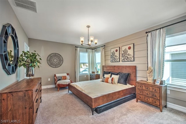 carpeted bedroom with a chandelier