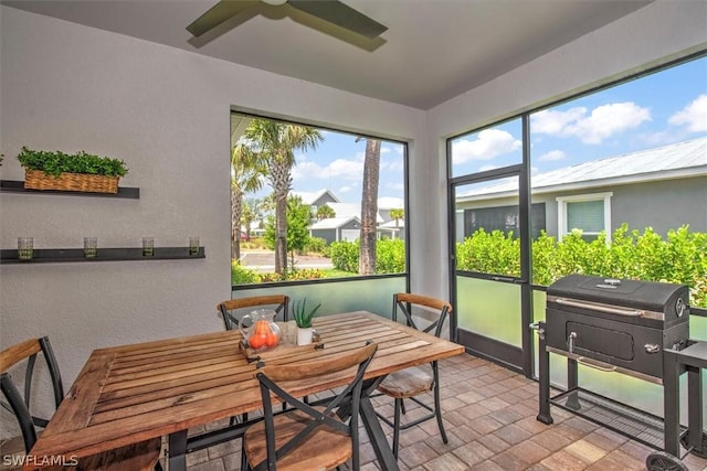 sunroom featuring ceiling fan