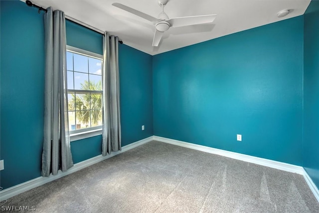 empty room featuring carpet flooring and ceiling fan