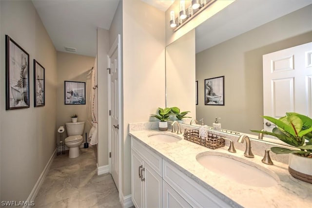 bathroom featuring vanity and toilet