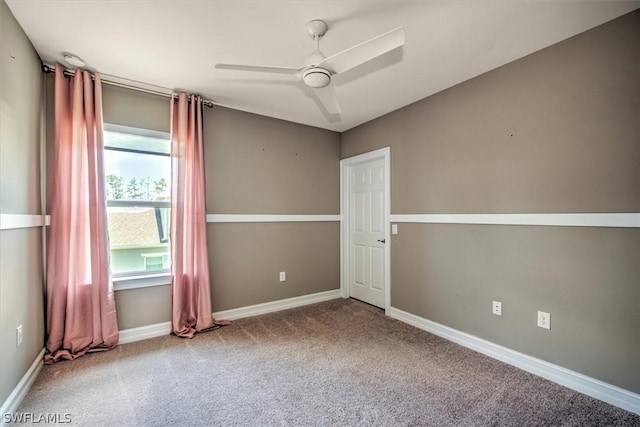 spare room with carpet, a wealth of natural light, and ceiling fan