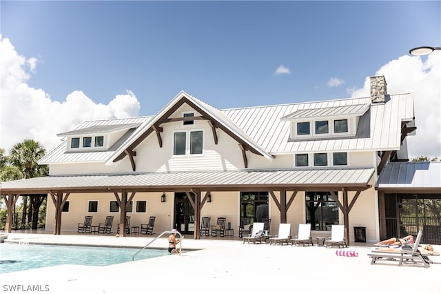 rear view of house with a patio area and a community pool