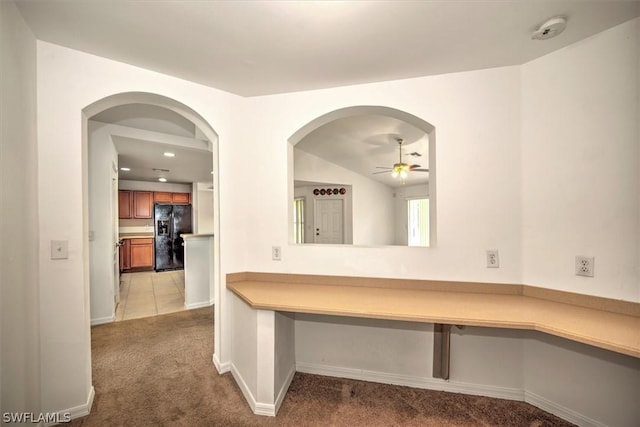 interior space with ceiling fan and light colored carpet