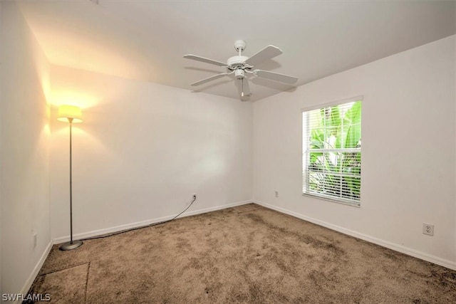 carpeted empty room featuring ceiling fan