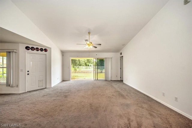 unfurnished living room featuring carpet flooring, ceiling fan, a healthy amount of sunlight, and lofted ceiling