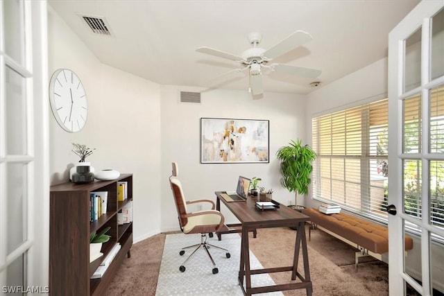 carpeted home office featuring ceiling fan