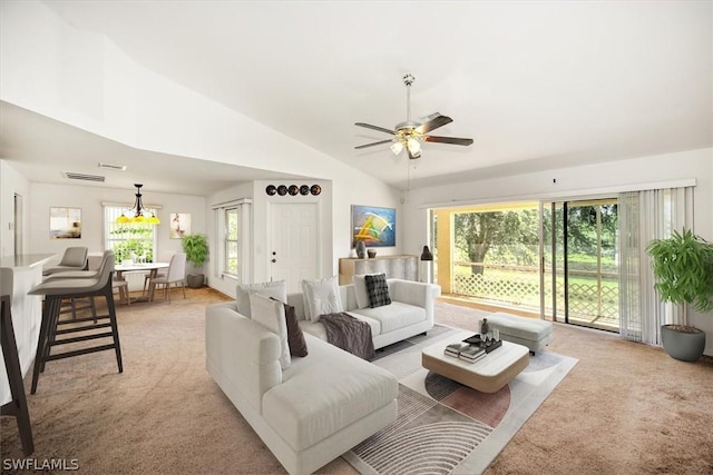 carpeted living room featuring ceiling fan and vaulted ceiling