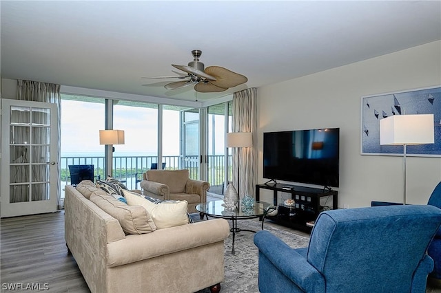 5550 Heron Point Dr Unit 1503, Naples, FL 34108 - living room with ceiling fan, wood finished floors, and a wall of windows