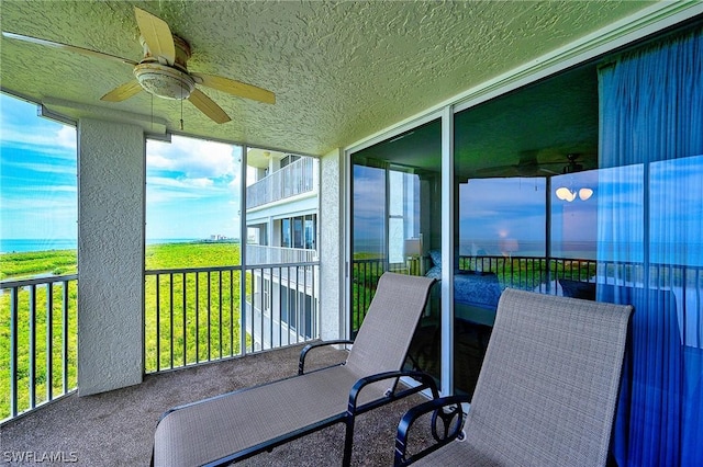 5550 Heron Point Dr Unit 1503, Naples, FL 34108 - sunroom / solarium featuring a ceiling fan, plenty of natural light, and a water view