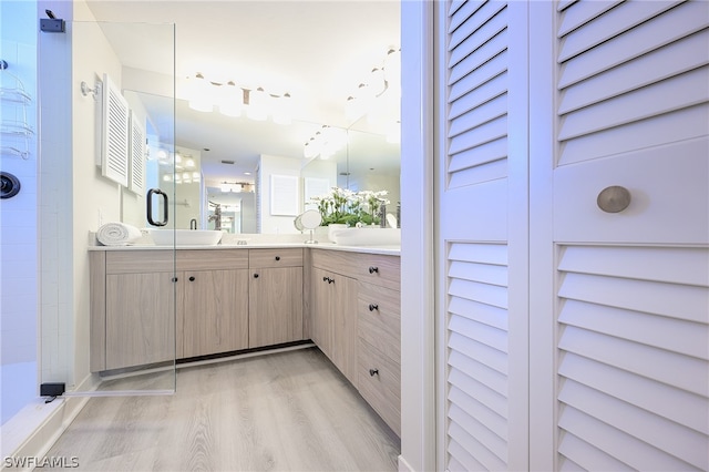 bathroom featuring a shower, vanity, and hardwood / wood-style flooring