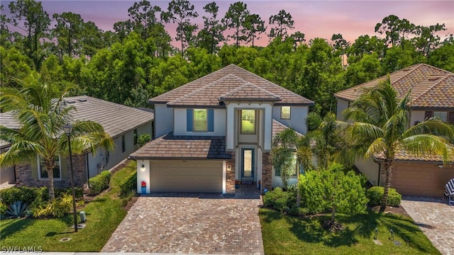 view of front facade featuring decorative driveway and stucco siding