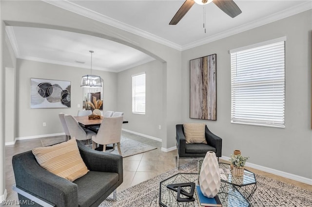 interior space featuring baseboards, arched walkways, crown molding, and light tile patterned flooring