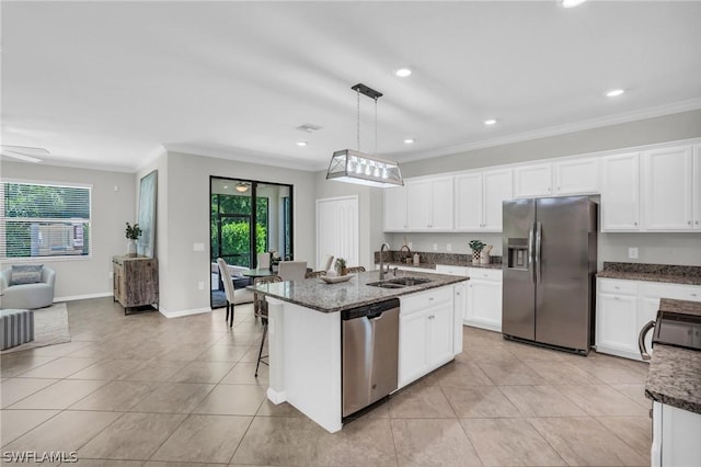 kitchen with light tile patterned floors, ornamental molding, stainless steel appliances, white cabinetry, and a sink