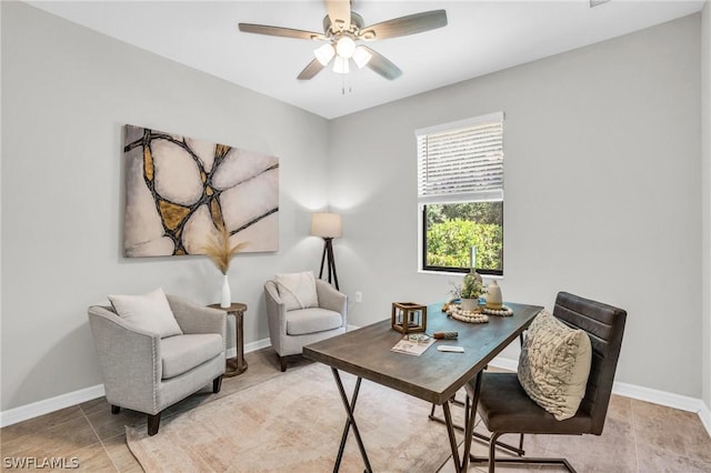 office space featuring ceiling fan, tile patterned flooring, and baseboards