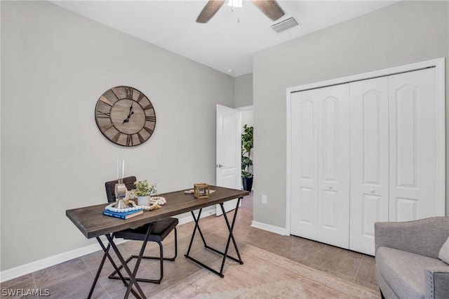 office area featuring ceiling fan, visible vents, baseboards, and light tile patterned flooring