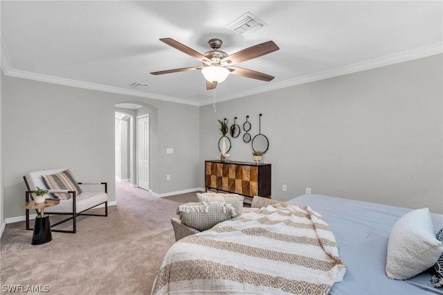 carpeted bedroom with ornamental molding, arched walkways, visible vents, and baseboards