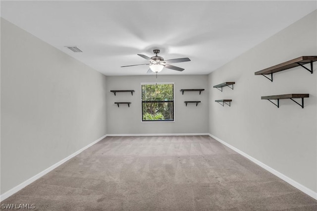 unfurnished room with ceiling fan, carpet flooring, visible vents, and baseboards