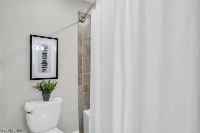 full bathroom with shower / tub combo and toilet