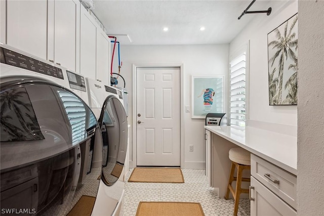 washroom featuring cabinets and separate washer and dryer