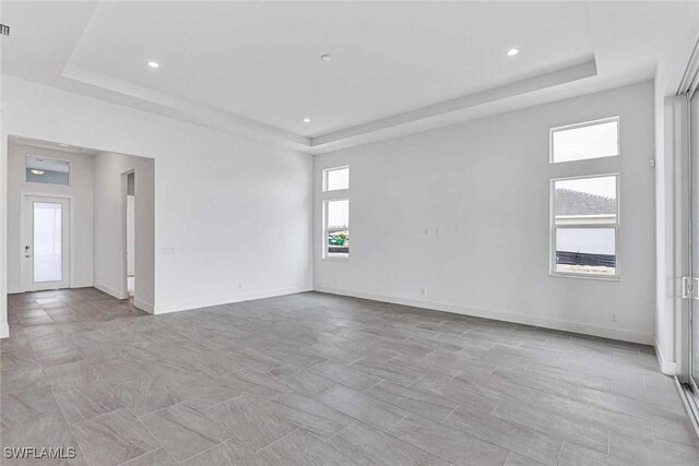 unfurnished room with a raised ceiling