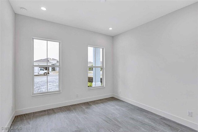 unfurnished room featuring hardwood / wood-style flooring and a wealth of natural light