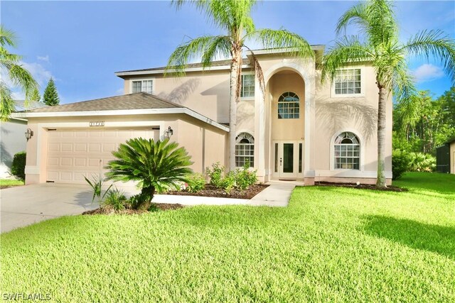 view of front facade with a garage and a front lawn