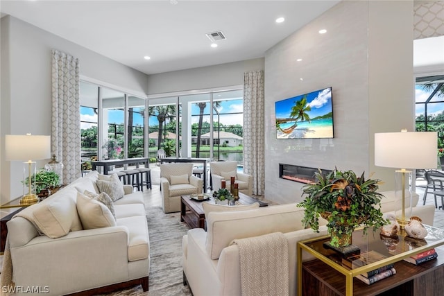 living room featuring a fireplace and plenty of natural light