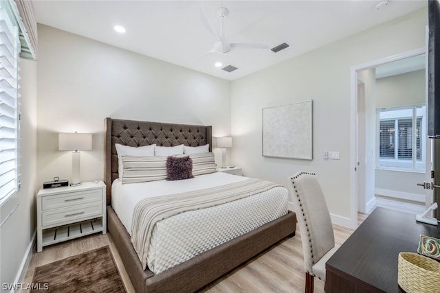 bedroom with multiple windows, light wood-type flooring, and ceiling fan