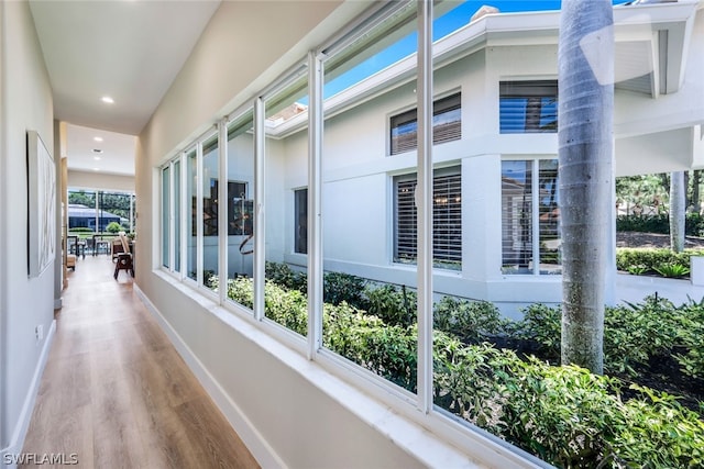 hallway with hardwood / wood-style flooring